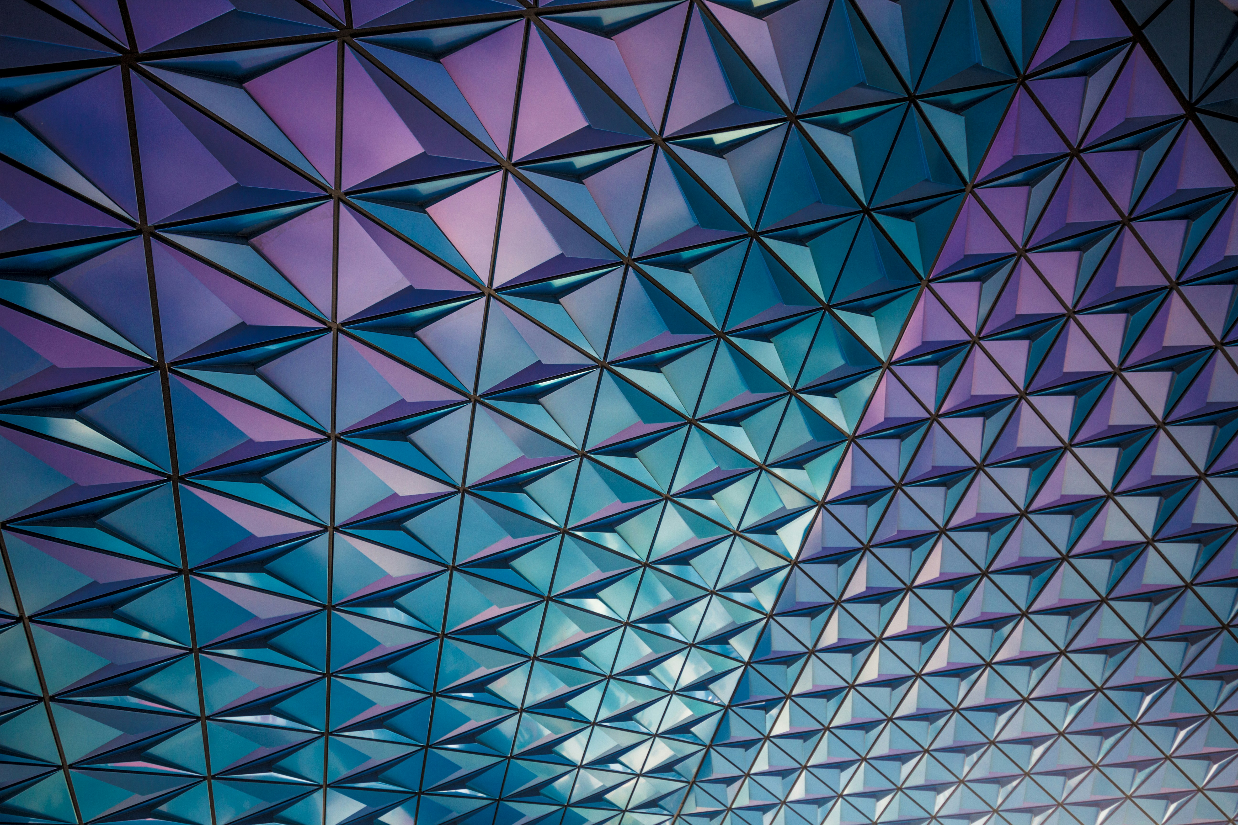 A geometric pattern adorns the ceiling of a building, showcasing intricate designs and symmetry.